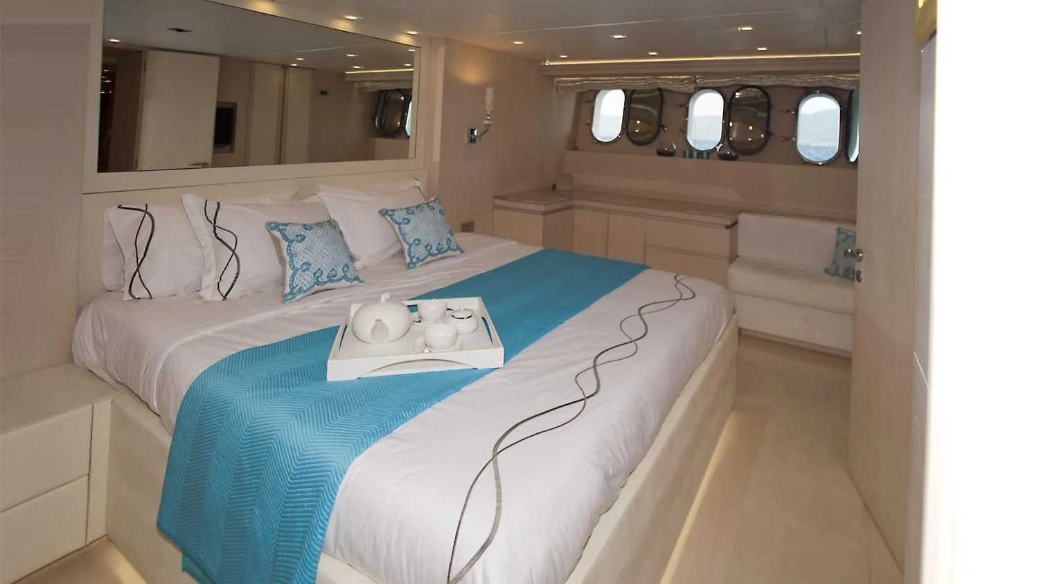 a bed with a blue sheet aboard TUSCAN SUN Yacht for Charter