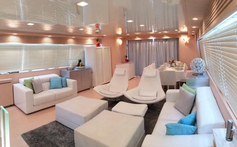 a room with white couches and a table aboard TUSCAN SUN Yacht for Charter