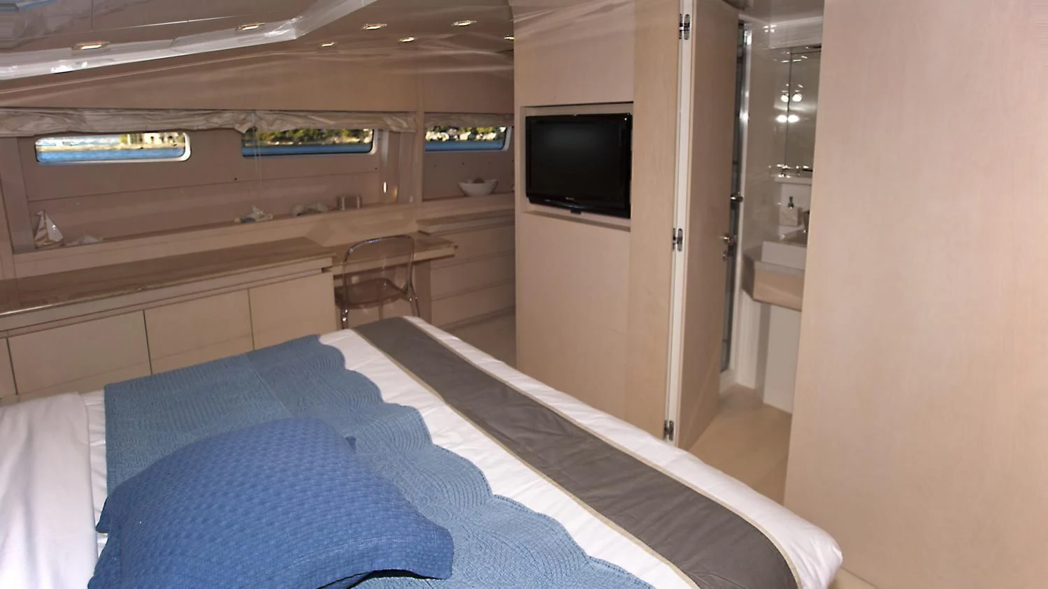 a room with a bed and a tv aboard TUSCAN SUN Yacht for Charter