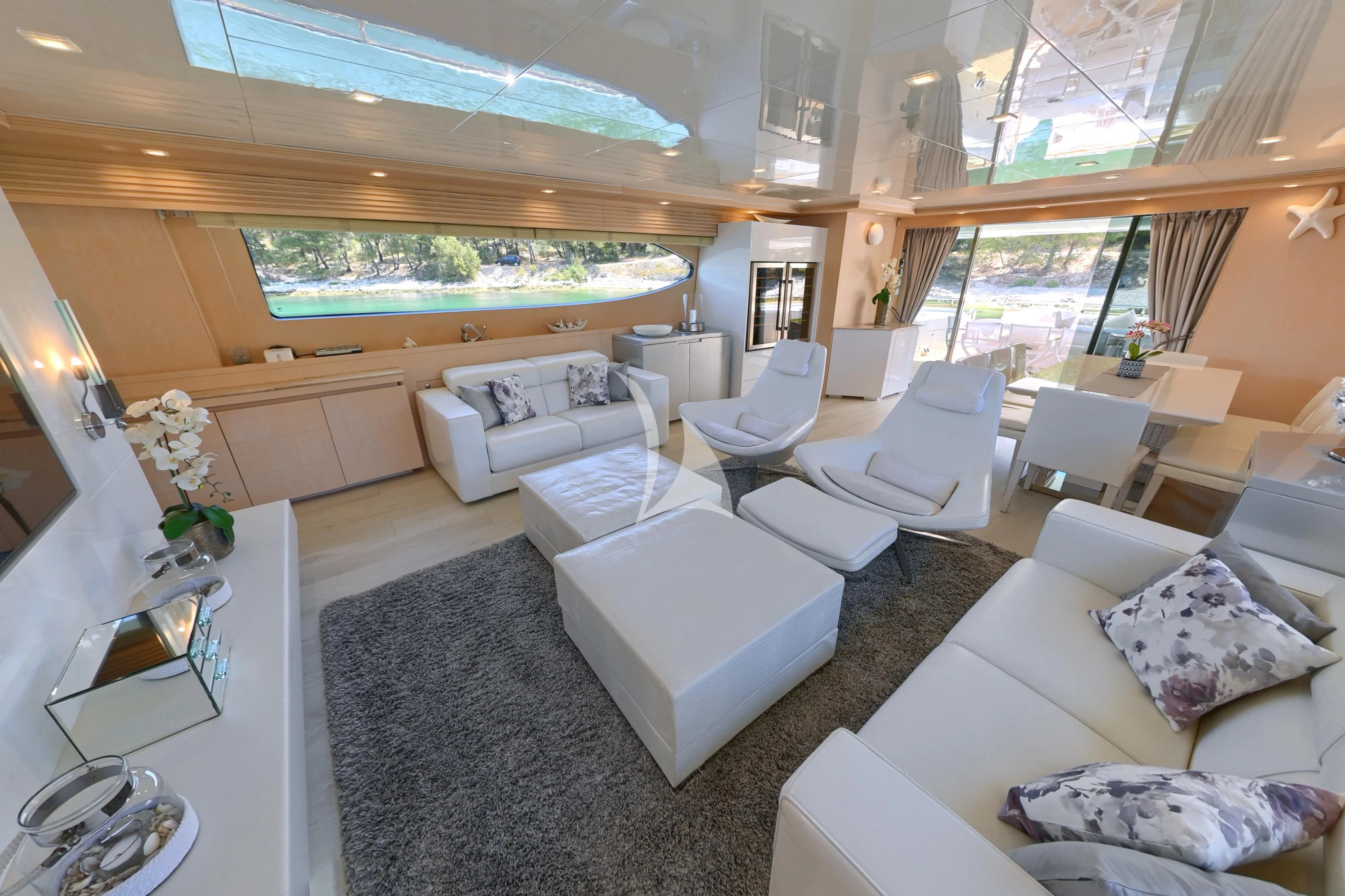 a large room with a couch and a table aboard TUSCAN SUN Yacht for Charter