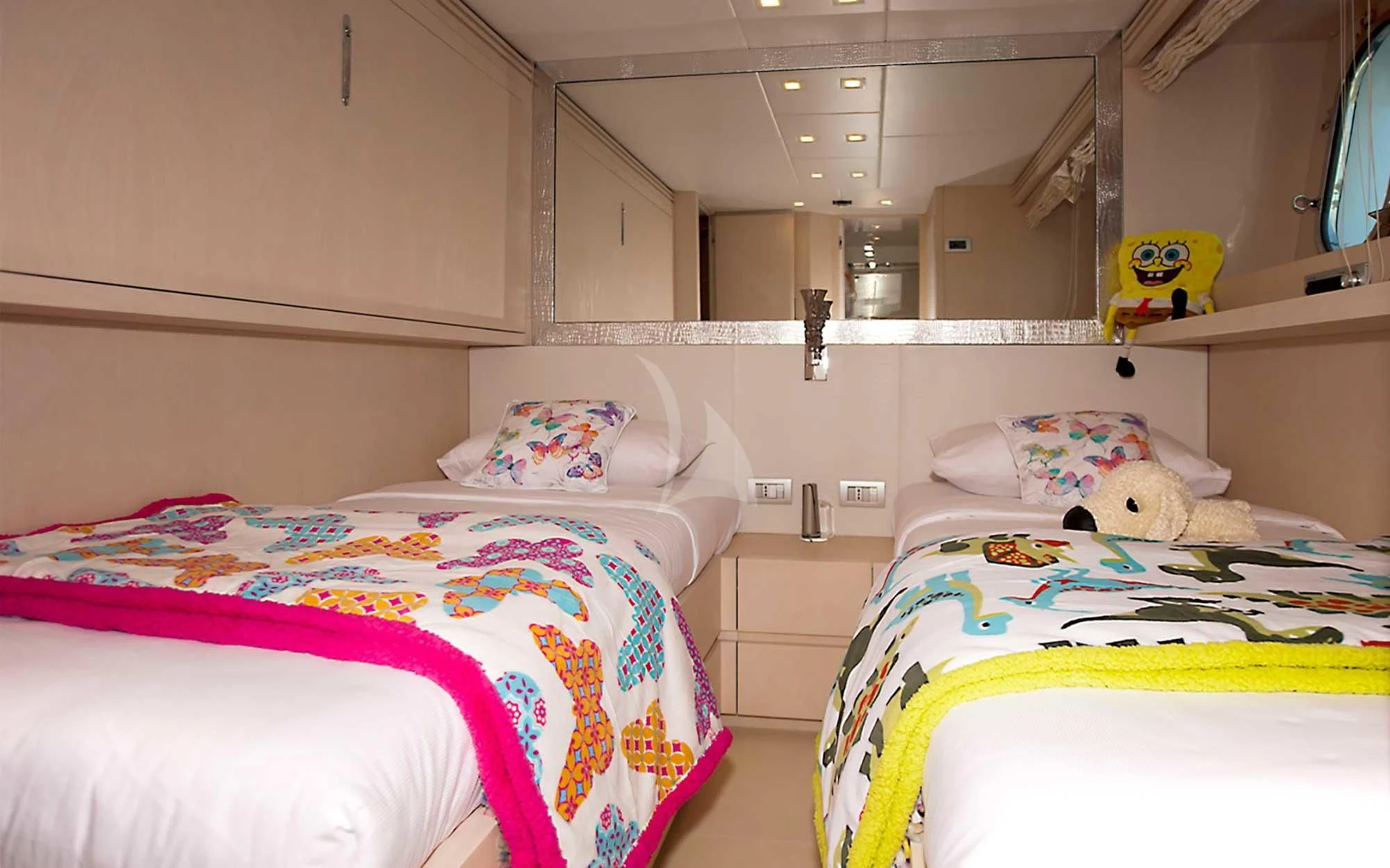 a room with beds and a shelf aboard TUSCAN SUN Yacht for Charter