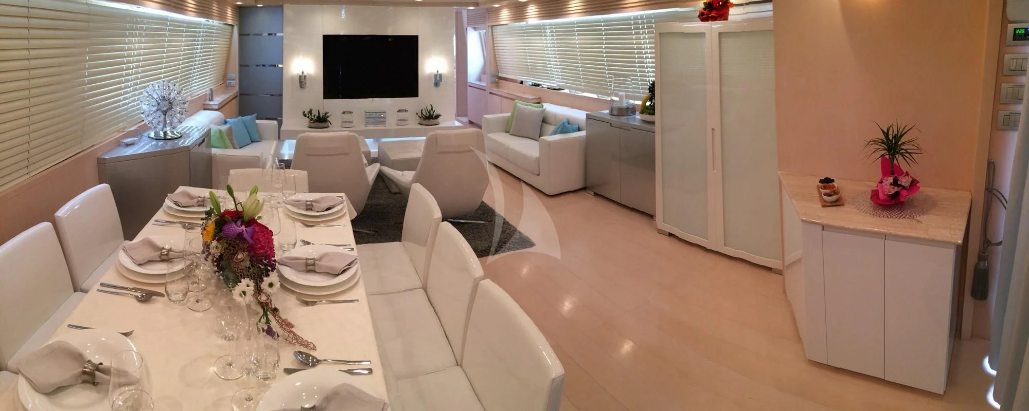 a room with a table chairs and a tv aboard TUSCAN SUN Yacht for Charter