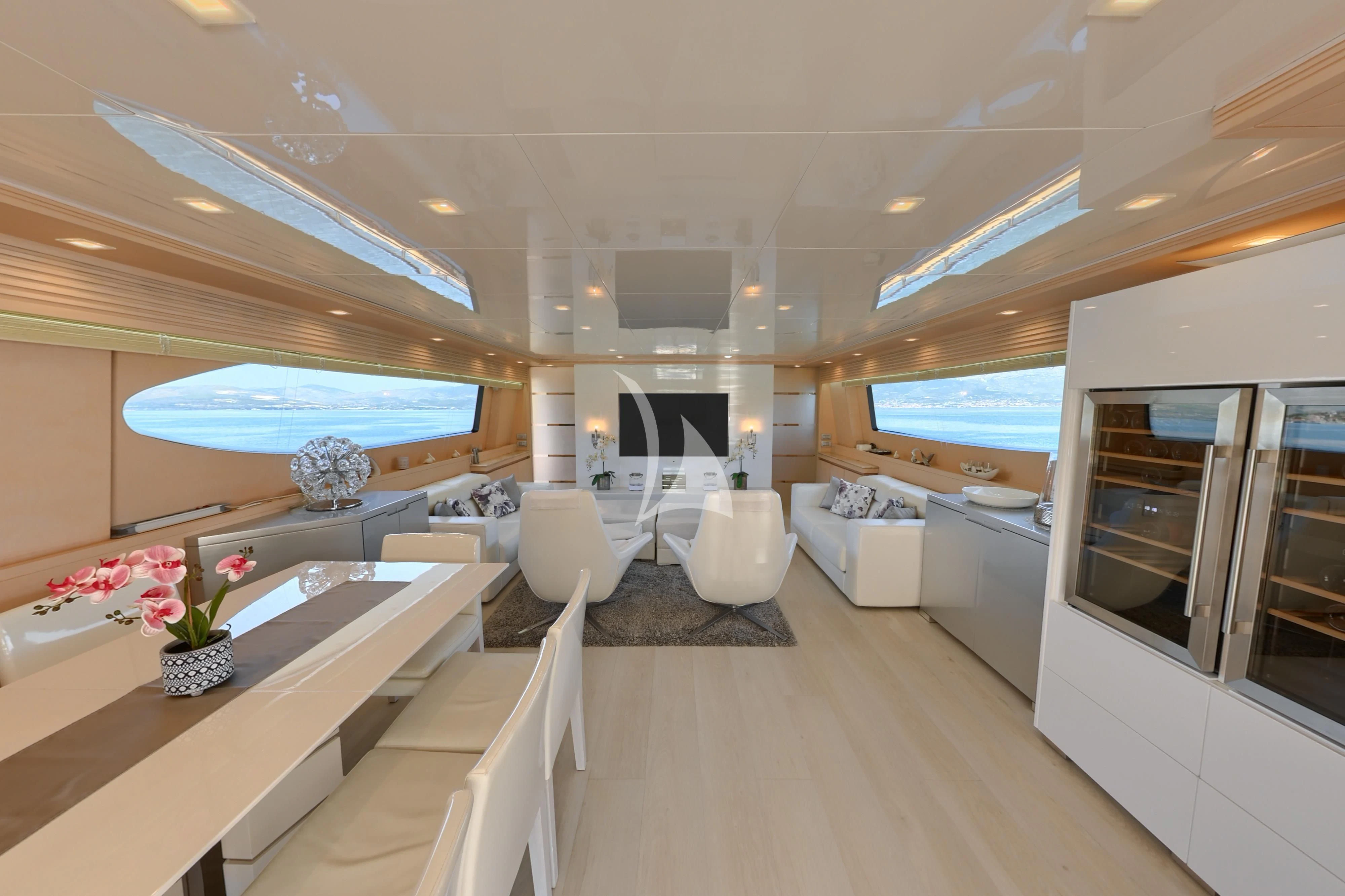 a room with a table chairs and a large window aboard TUSCAN SUN Yacht for Charter