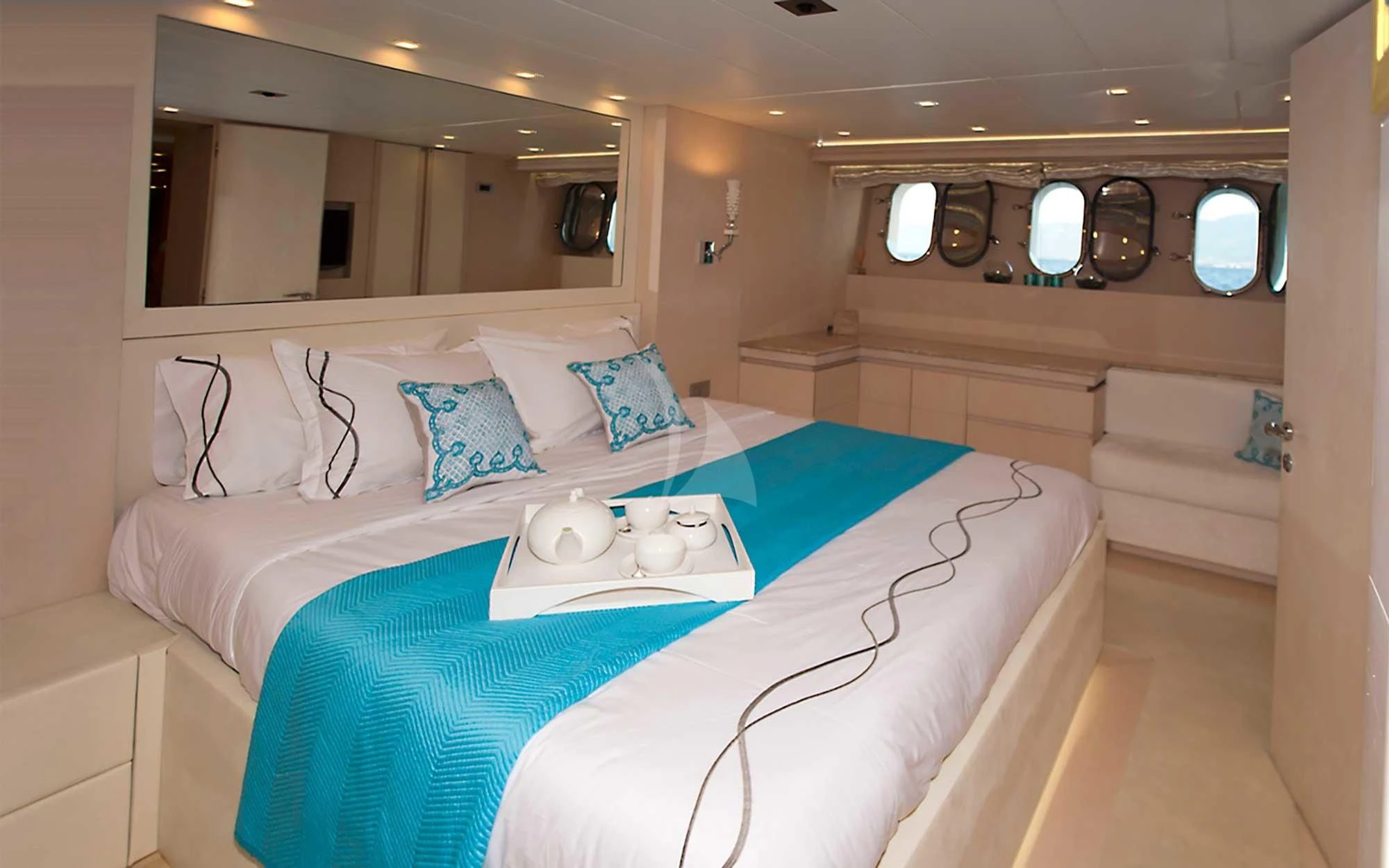 a bed with a blue sheet aboard TUSCAN SUN Yacht for Charter