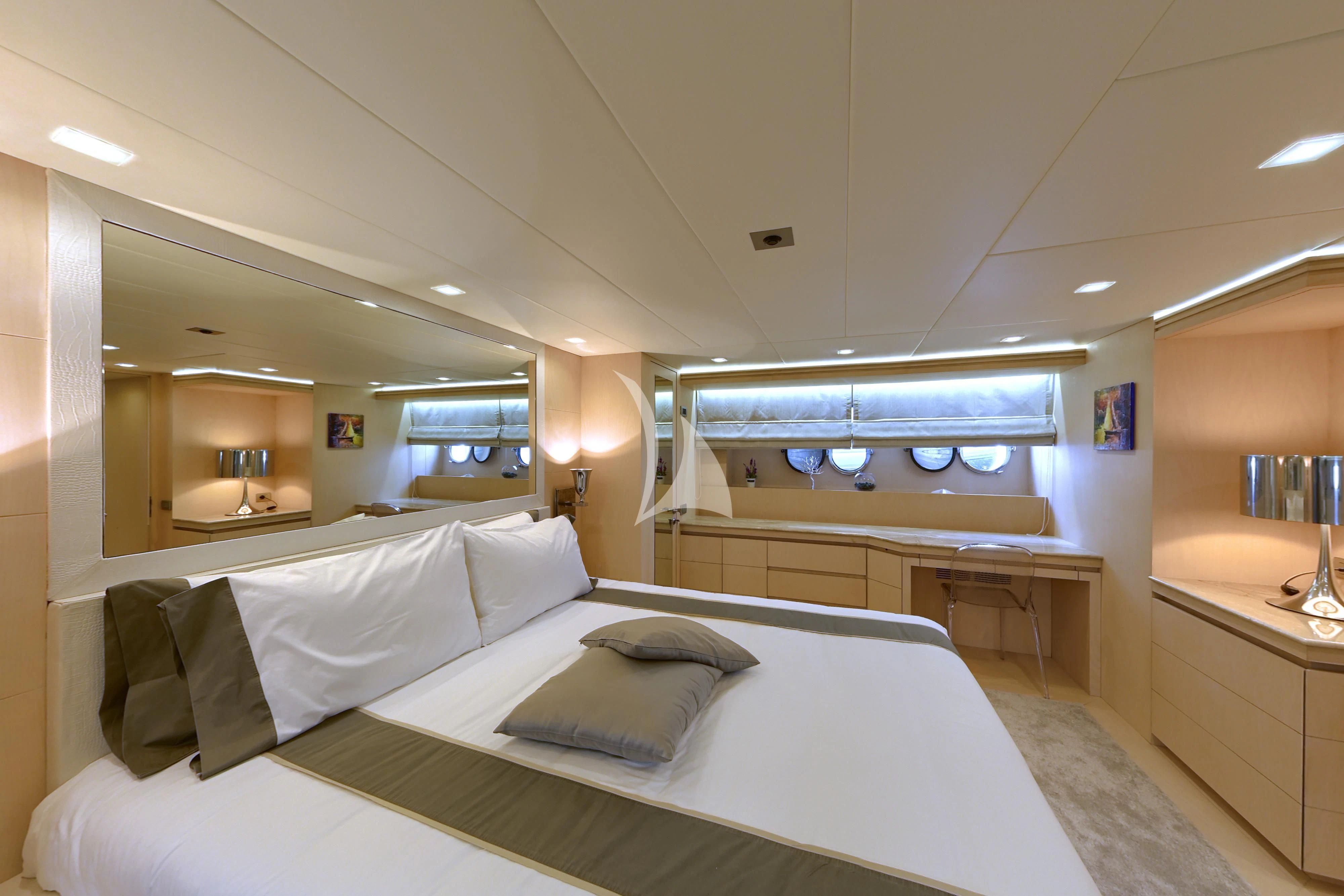 a room with a bed and a large mirror aboard TUSCAN SUN Yacht for Charter