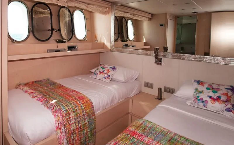 a couple of beds in a room aboard TUSCAN SUN Yacht for Charter