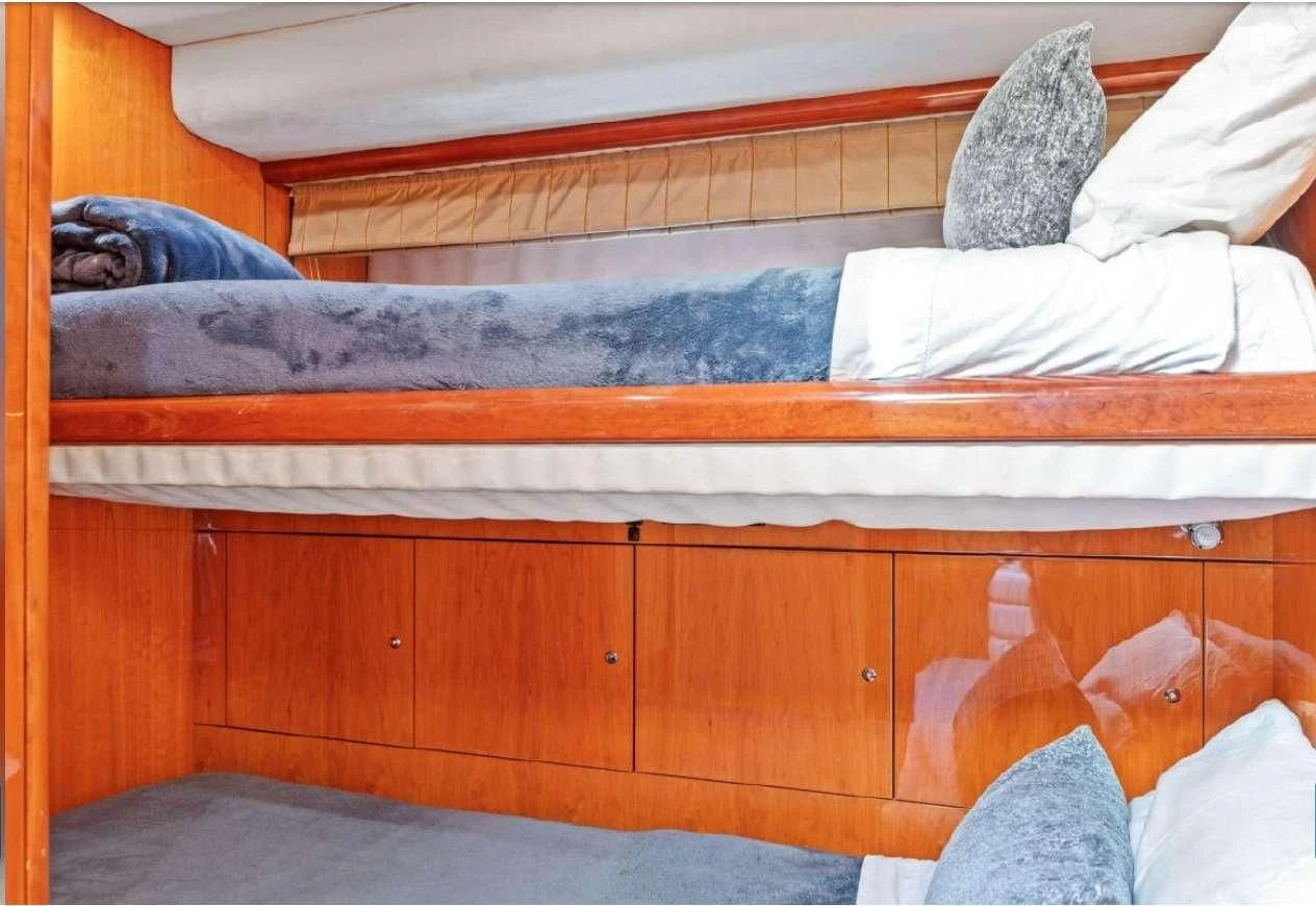 a wooden shelf with white sheets aboard QUANTUM Yacht for Sale