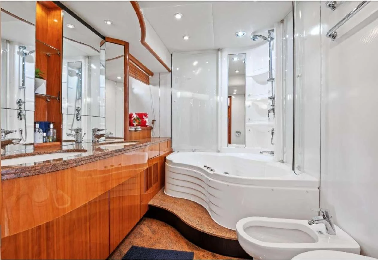a bathroom with a tub sink and toilet aboard QUANTUM Yacht for Sale