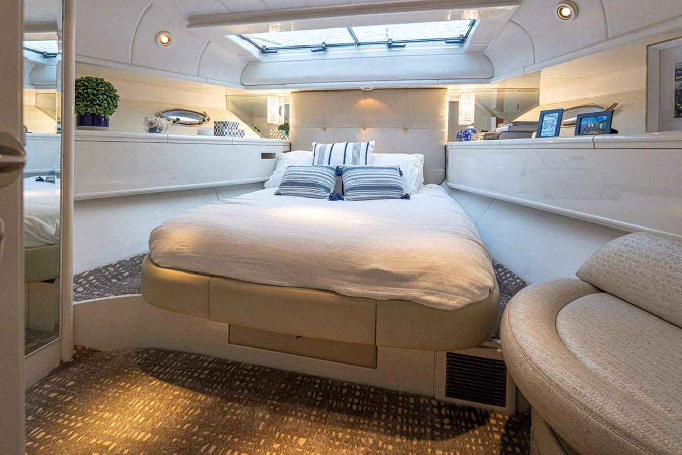 a room with a bed and a couch aboard UNDAUNTED Yacht for Sale