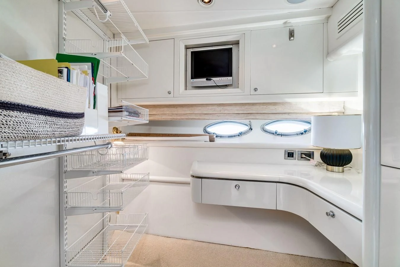 a white kitchen with a microwave oven aboard UNDAUNTED Yacht for Sale