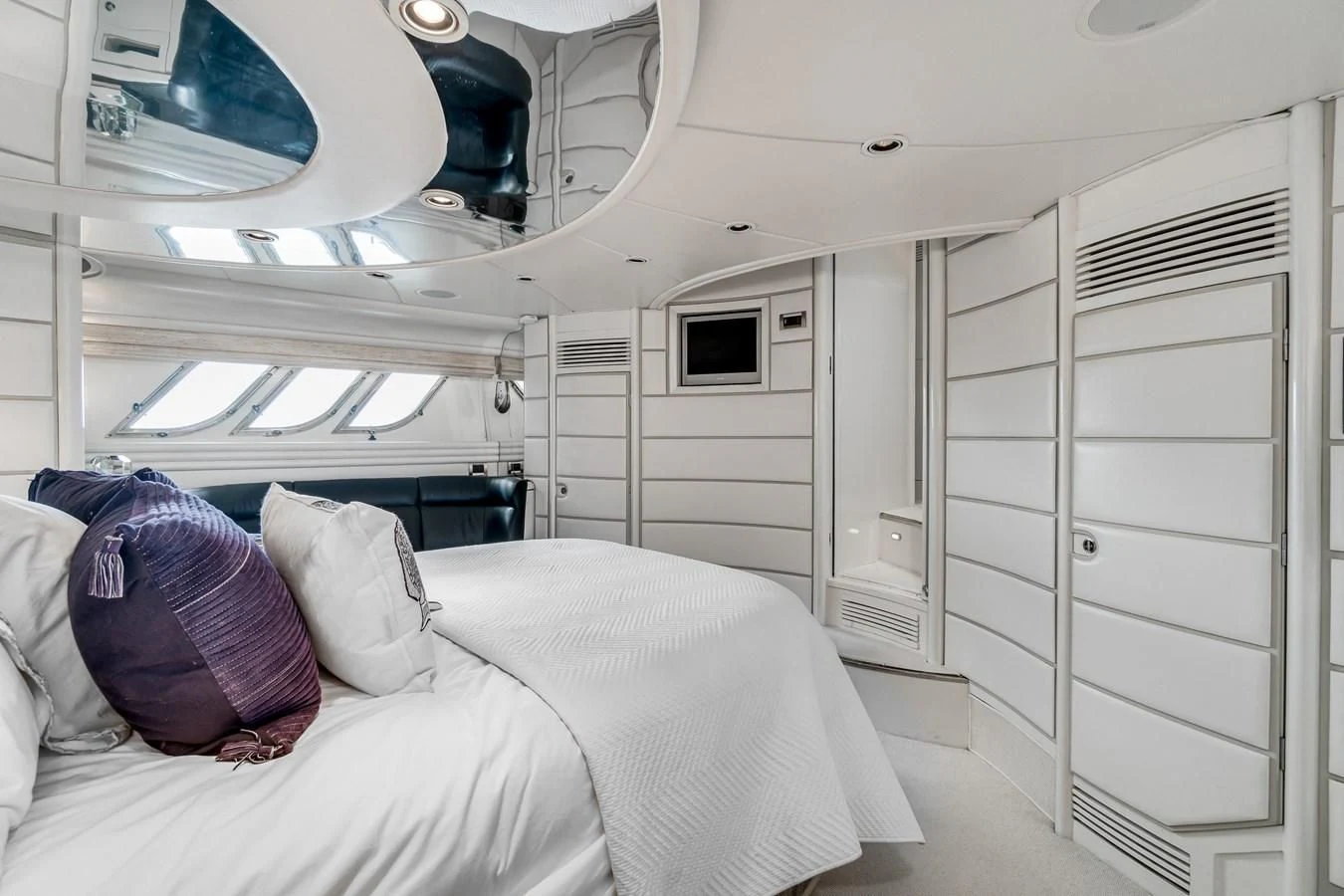 a room with a bed and a closet aboard UNDAUNTED Yacht for Sale