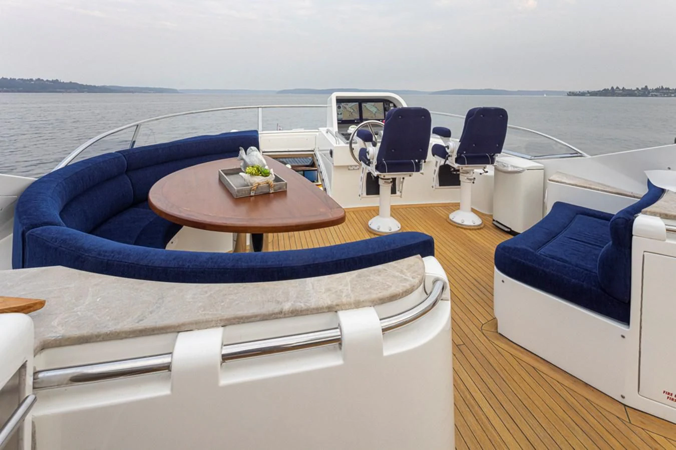 a boat with a table and chairs on it aboard UNDAUNTED Yacht for Sale