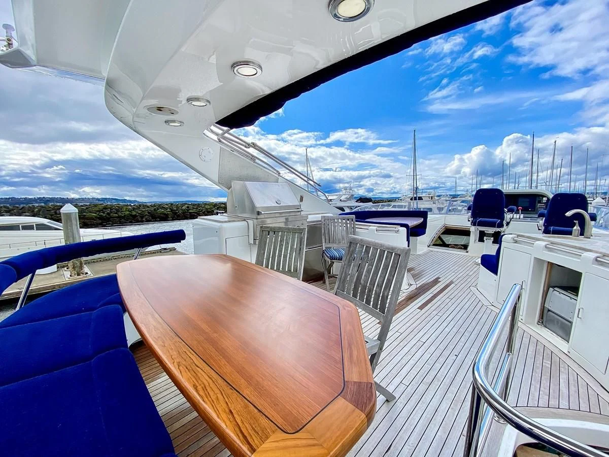 a deck with a view of a city and water aboard UNDAUNTED Yacht for Sale