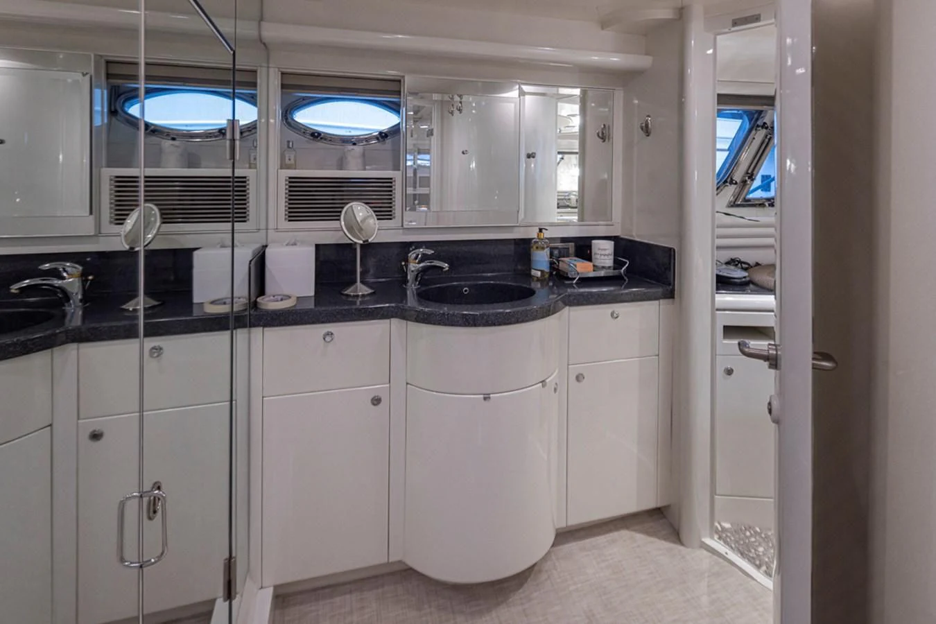 a kitchen with white cabinets aboard UNDAUNTED Yacht for Sale