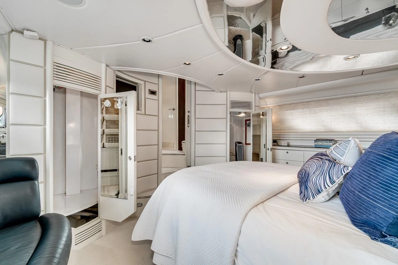 a room with a bed and a chair aboard UNDAUNTED Yacht for Sale