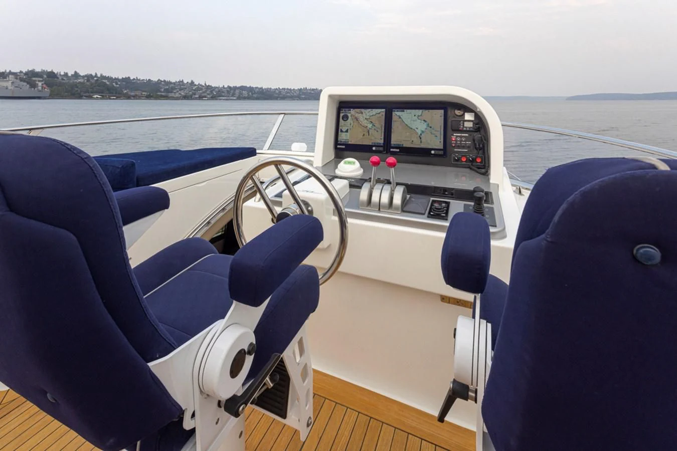 a boat with a steering wheel and seats on a boat aboard UNDAUNTED Yacht for Sale