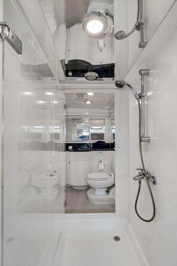 a bathroom with a shower and toilet aboard UNDAUNTED Yacht for Sale