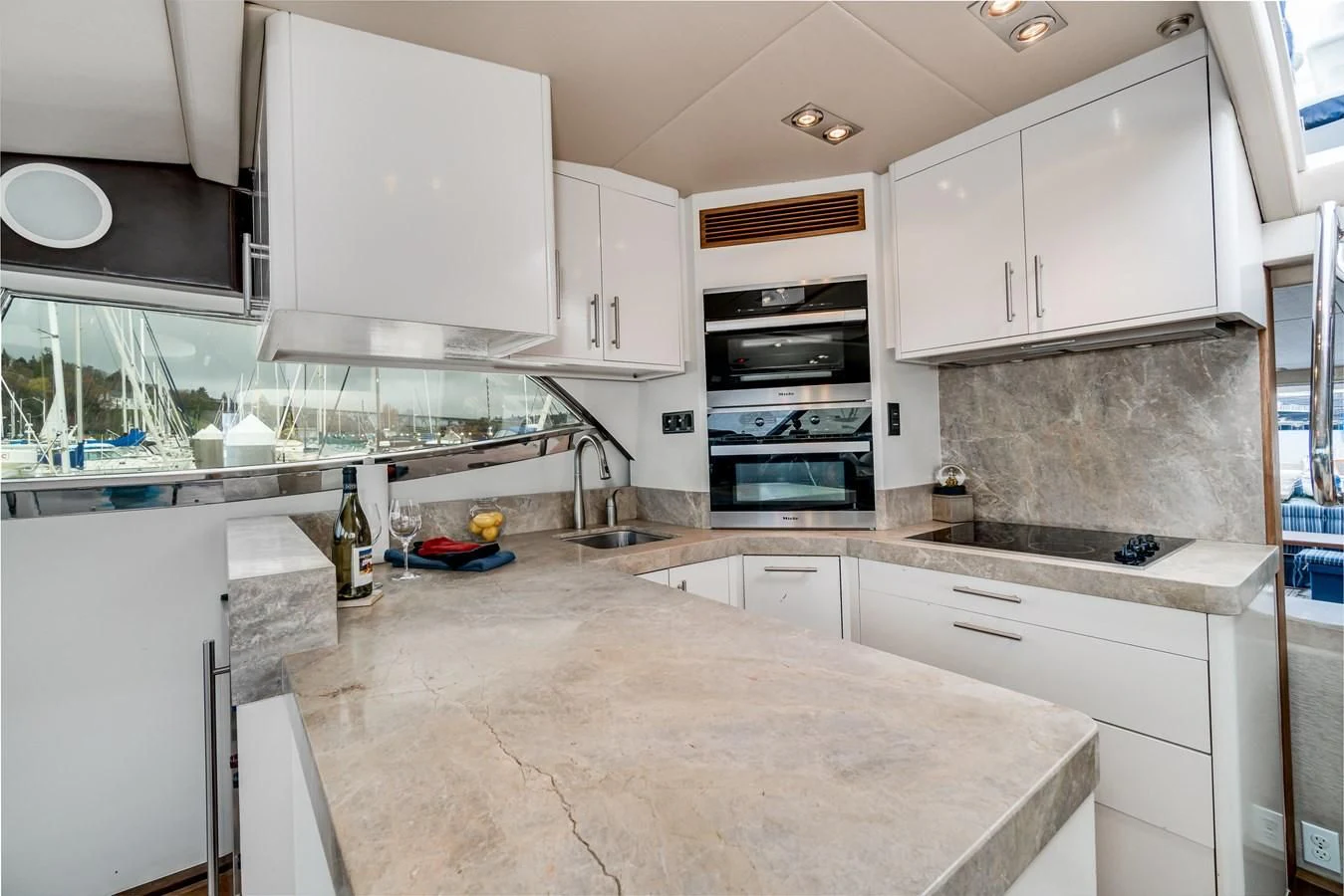 a kitchen with white cabinets aboard UNDAUNTED Yacht for Sale