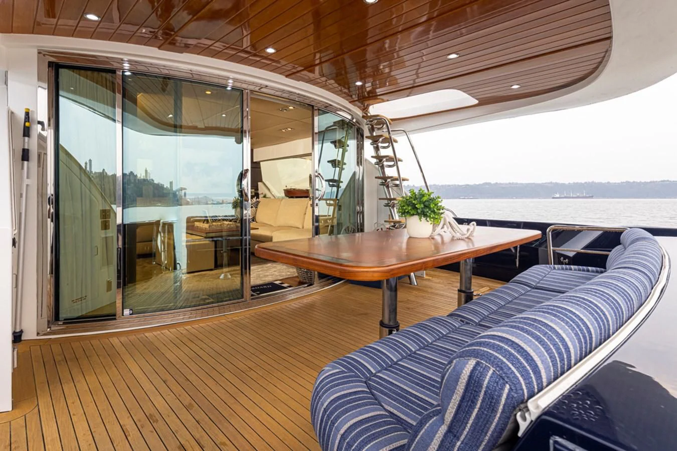 a room with a table and a couch aboard UNDAUNTED Yacht for Sale
