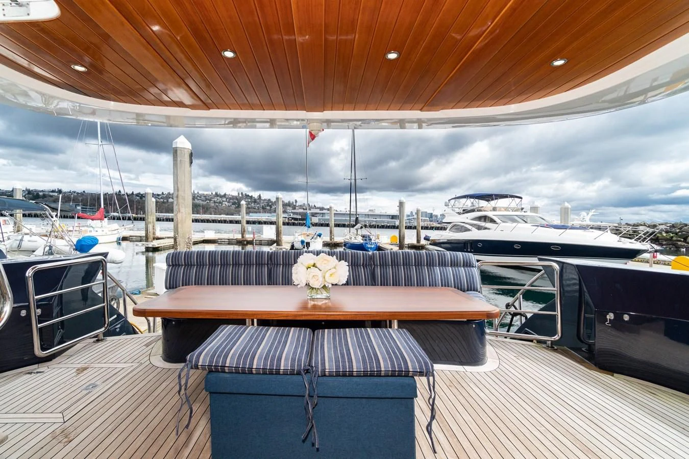 a deck with a table and chairs aboard UNDAUNTED Yacht for Sale