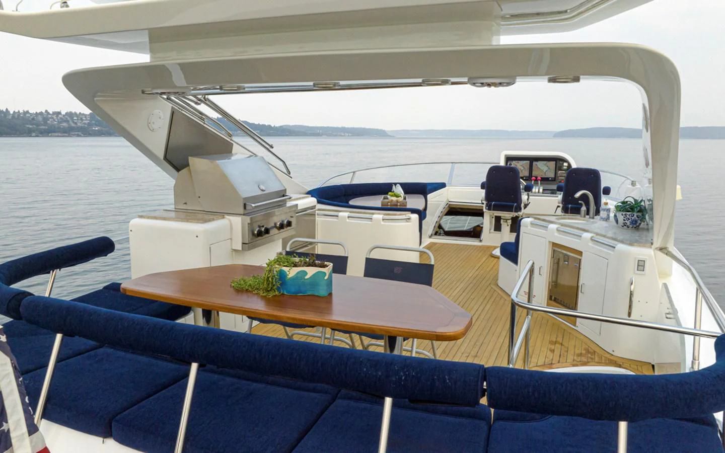 a boat with a table and chairs aboard UNDAUNTED Yacht for Sale