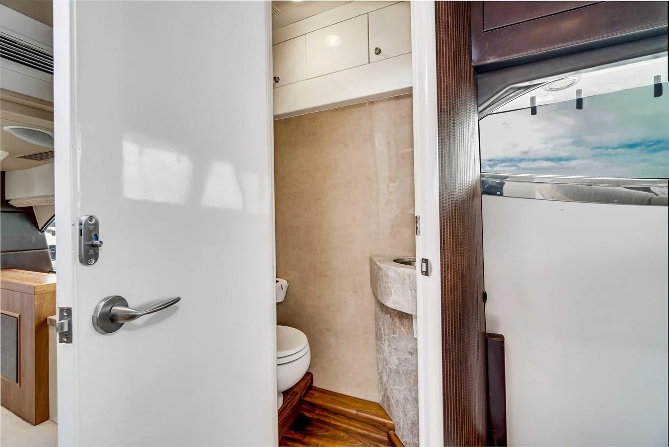 a bathroom with a toilet and a sink aboard UNDAUNTED Yacht for Sale