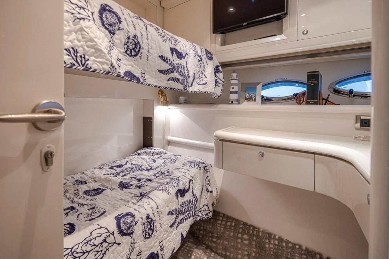 a small room with a bed and a sink aboard UNDAUNTED Yacht for Sale