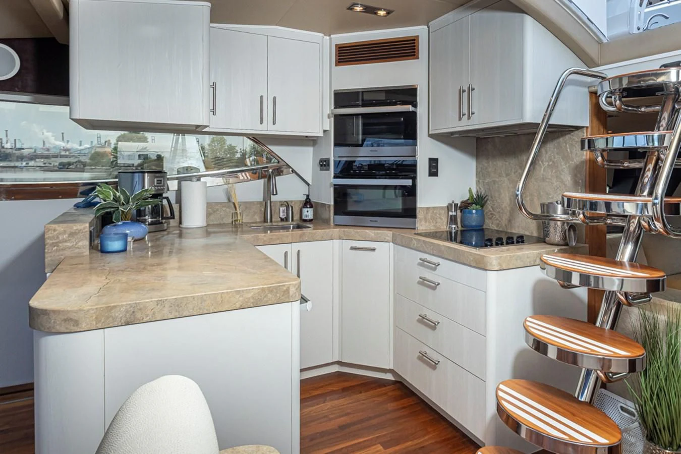a kitchen with white cabinets aboard UNDAUNTED Yacht for Sale