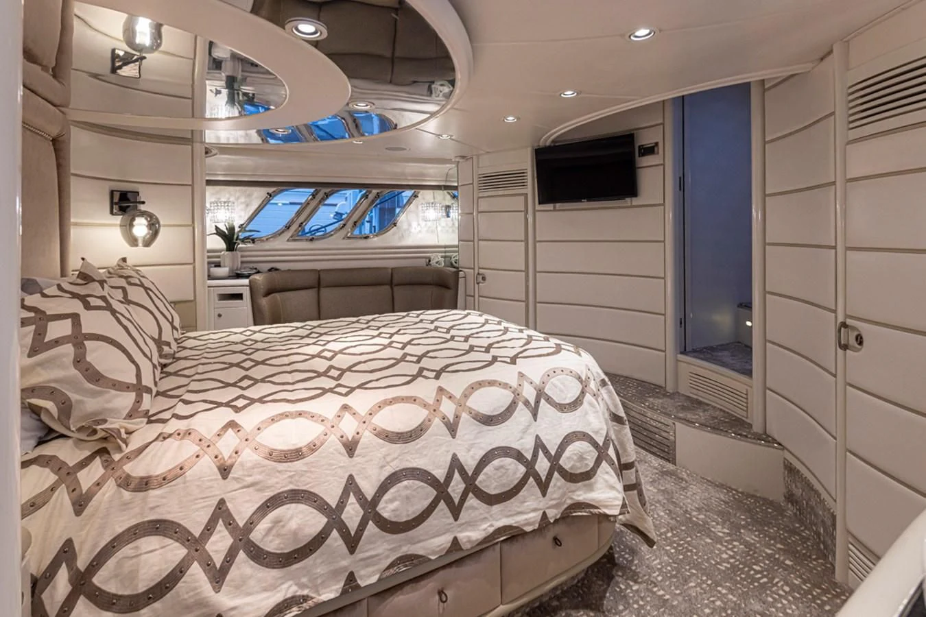 a room with a bed and a window aboard UNDAUNTED Yacht for Sale