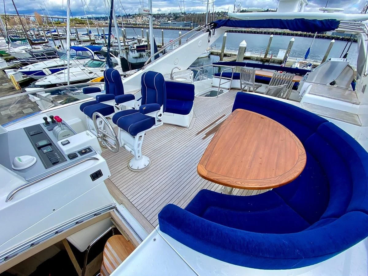 a deck with a pool and chairs aboard UNDAUNTED Yacht for Sale