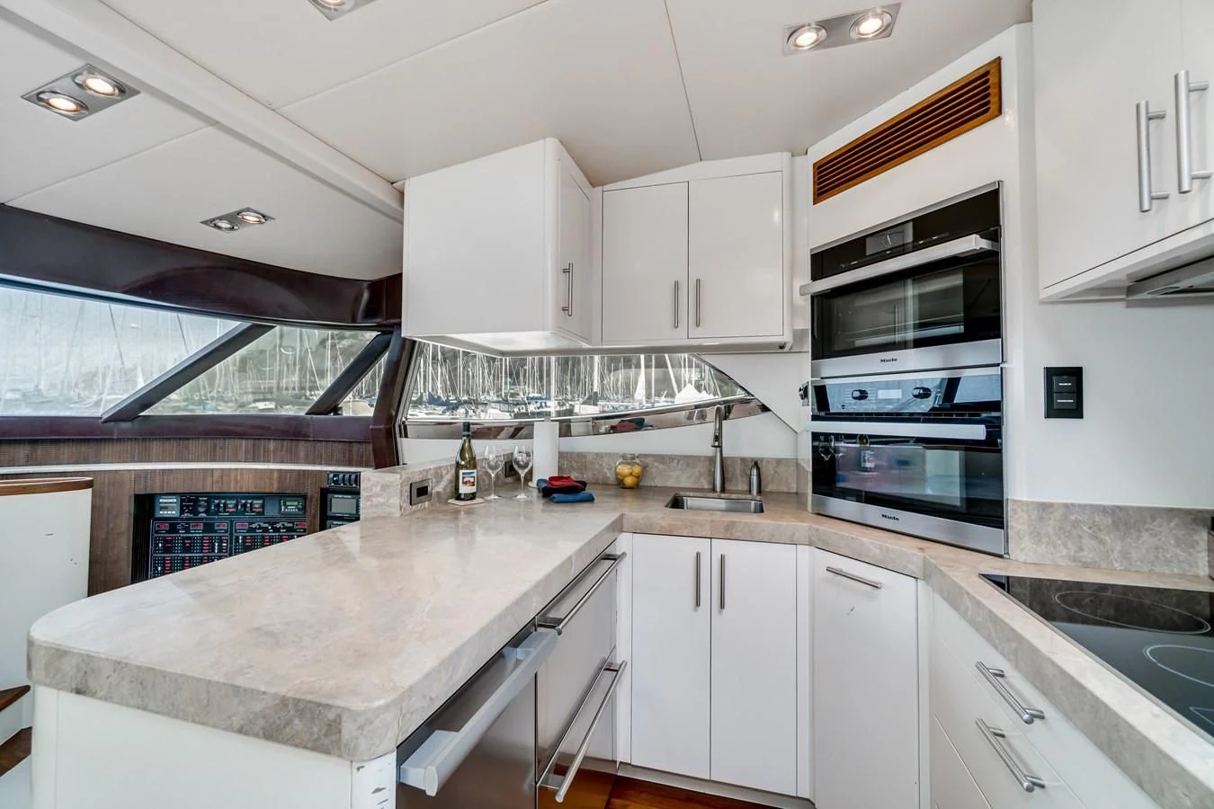a kitchen with white cabinets aboard UNDAUNTED Yacht for Sale