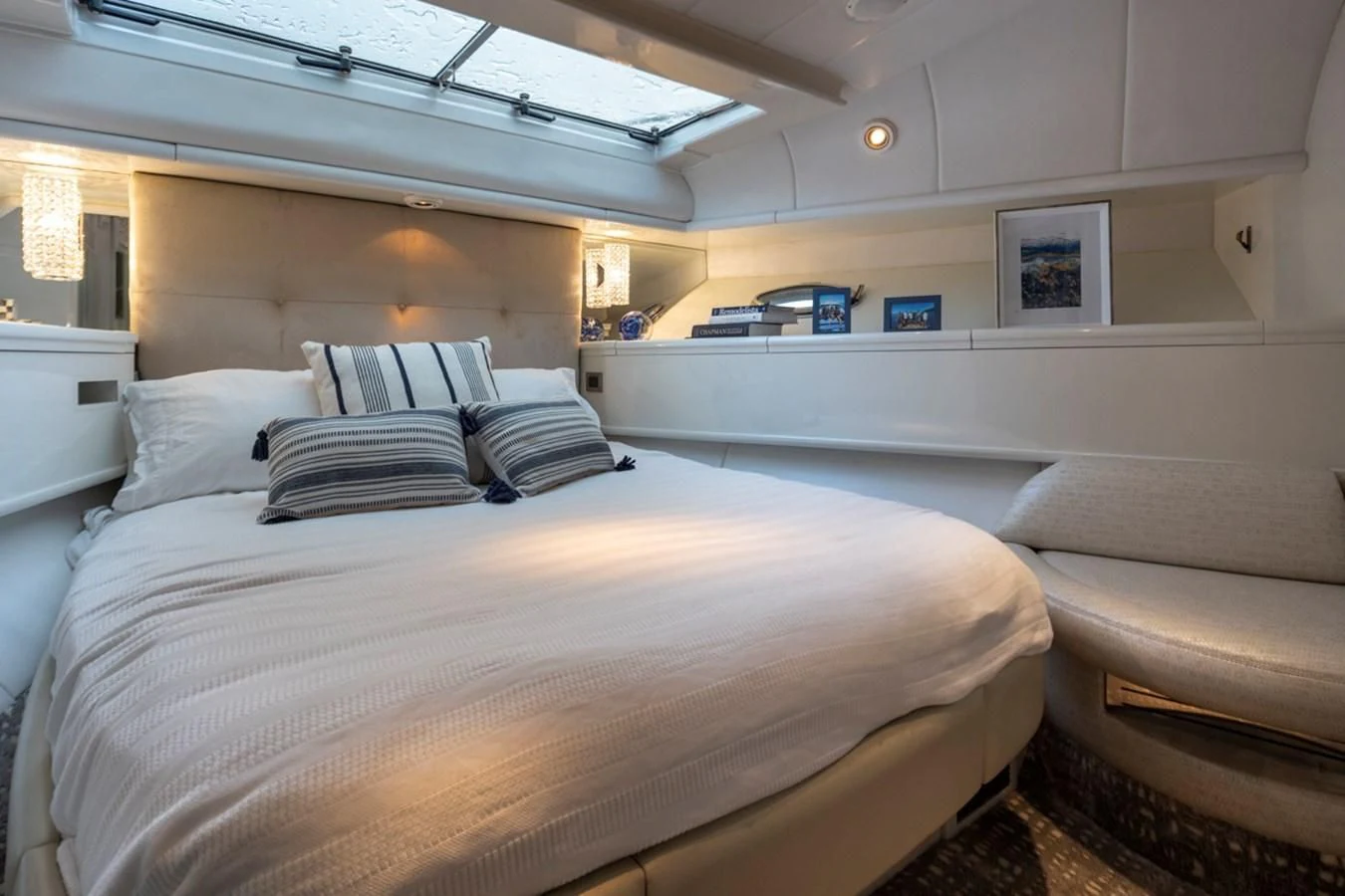 a room with a bed and a couch aboard UNDAUNTED Yacht for Sale