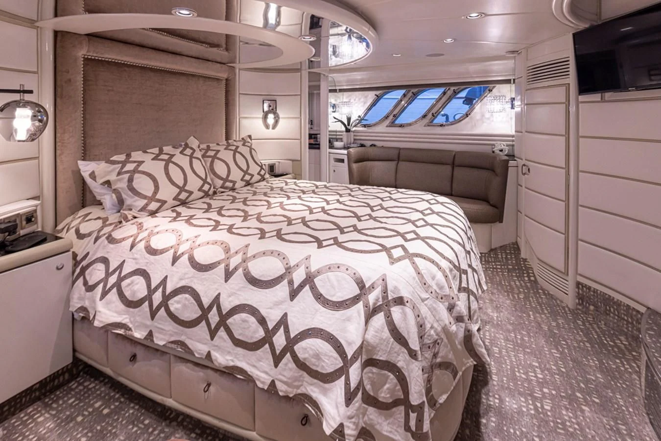 a room with a bed and a large window aboard UNDAUNTED Yacht for Sale
