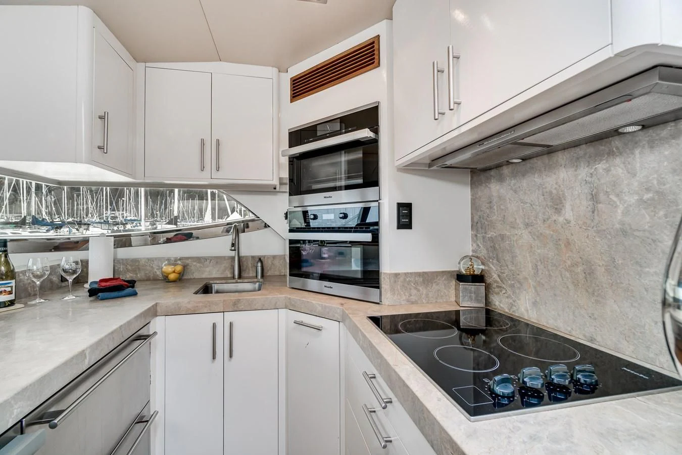 a kitchen with white cabinets aboard UNDAUNTED Yacht for Sale