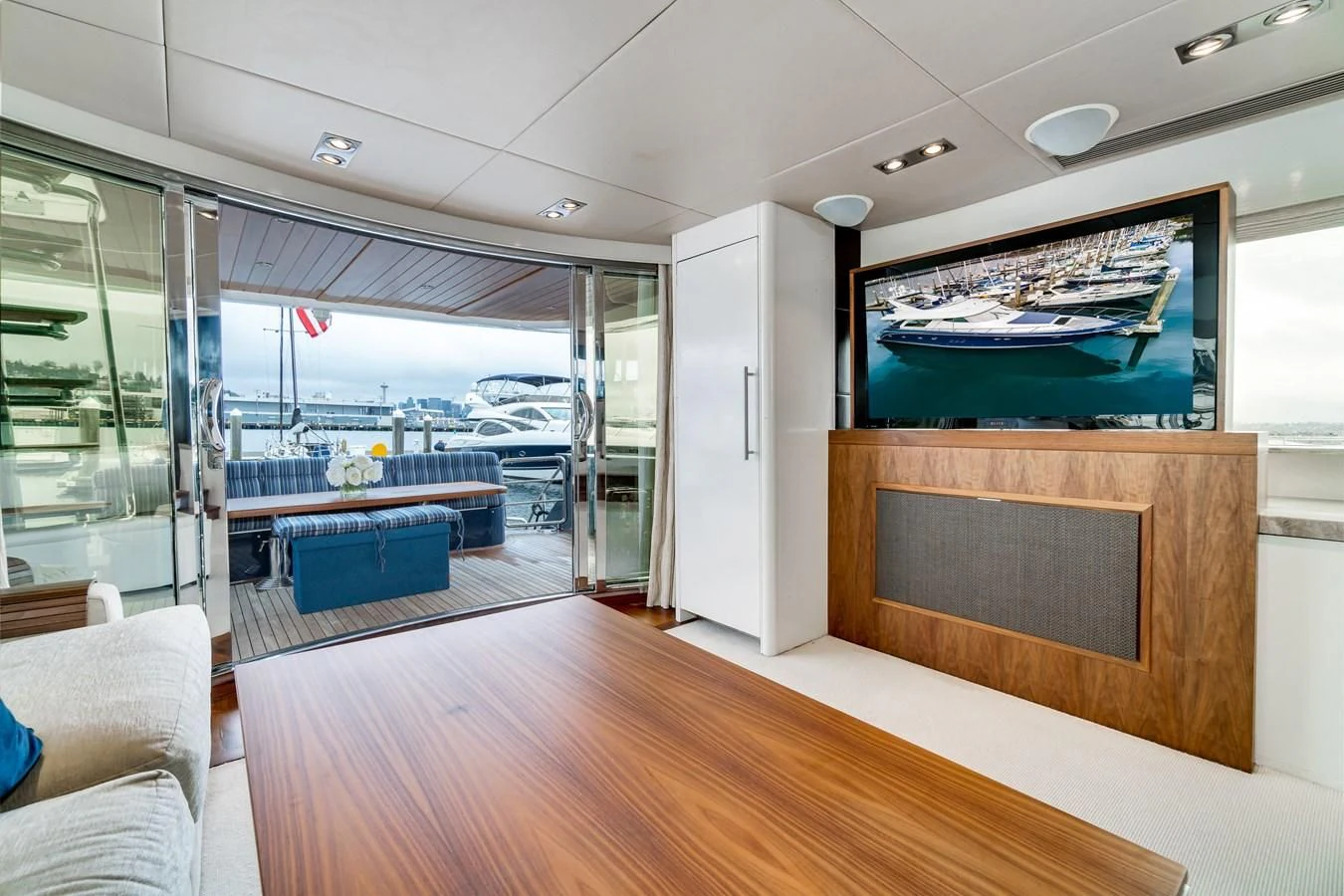 a room with a large glass door and a large pool table aboard UNDAUNTED Yacht for Sale