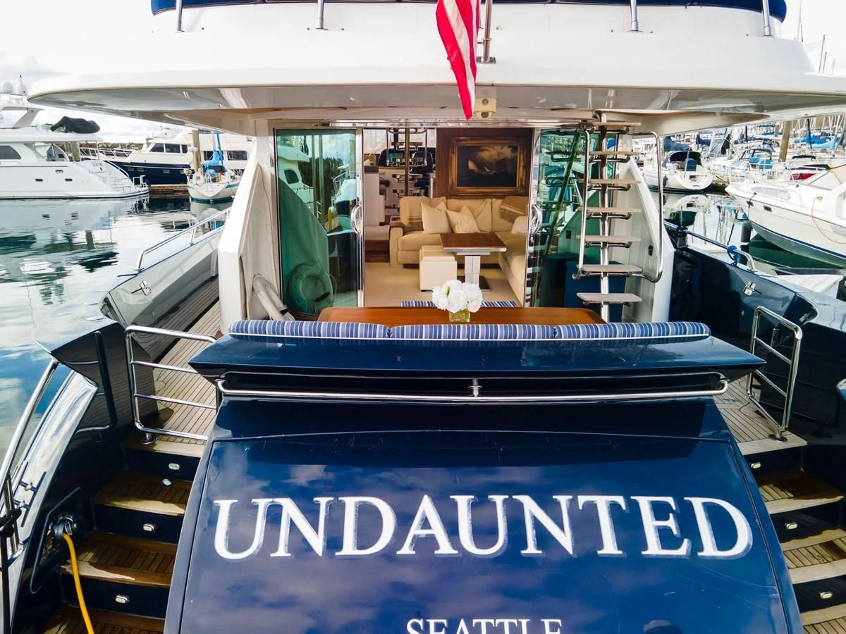 a boat with a chair on the deck aboard UNDAUNTED Yacht for Sale