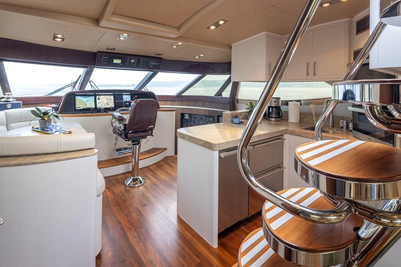 a room with a desk and chairs aboard UNDAUNTED Yacht for Sale