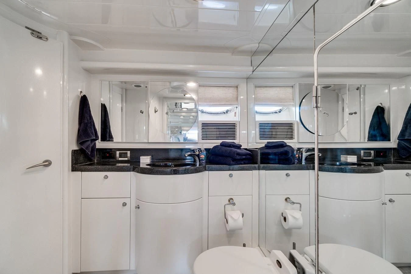 a bathroom with white cabinets aboard UNDAUNTED Yacht for Sale