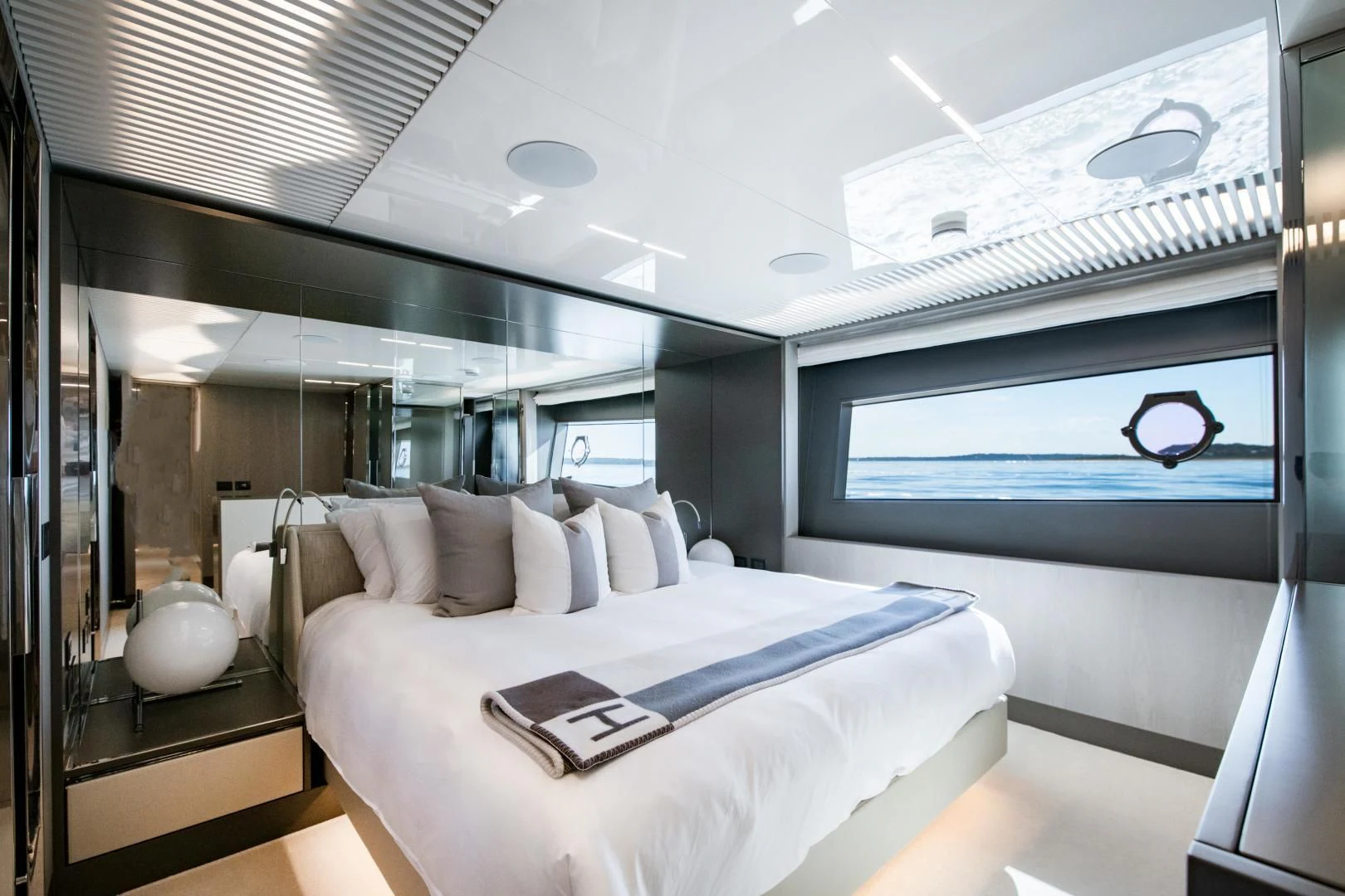 a room with a bed and a large window aboard ISLA MARIE Yacht for Sale