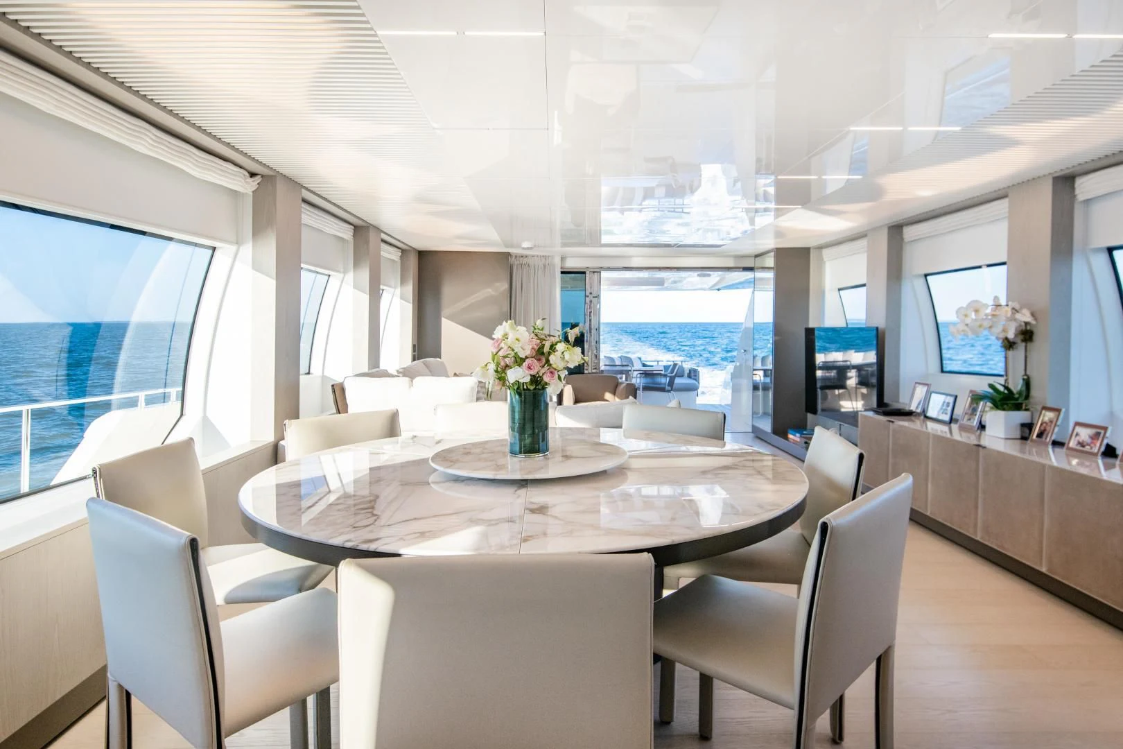 a room with a table chairs and a window aboard ISLA MARIE Yacht for Sale