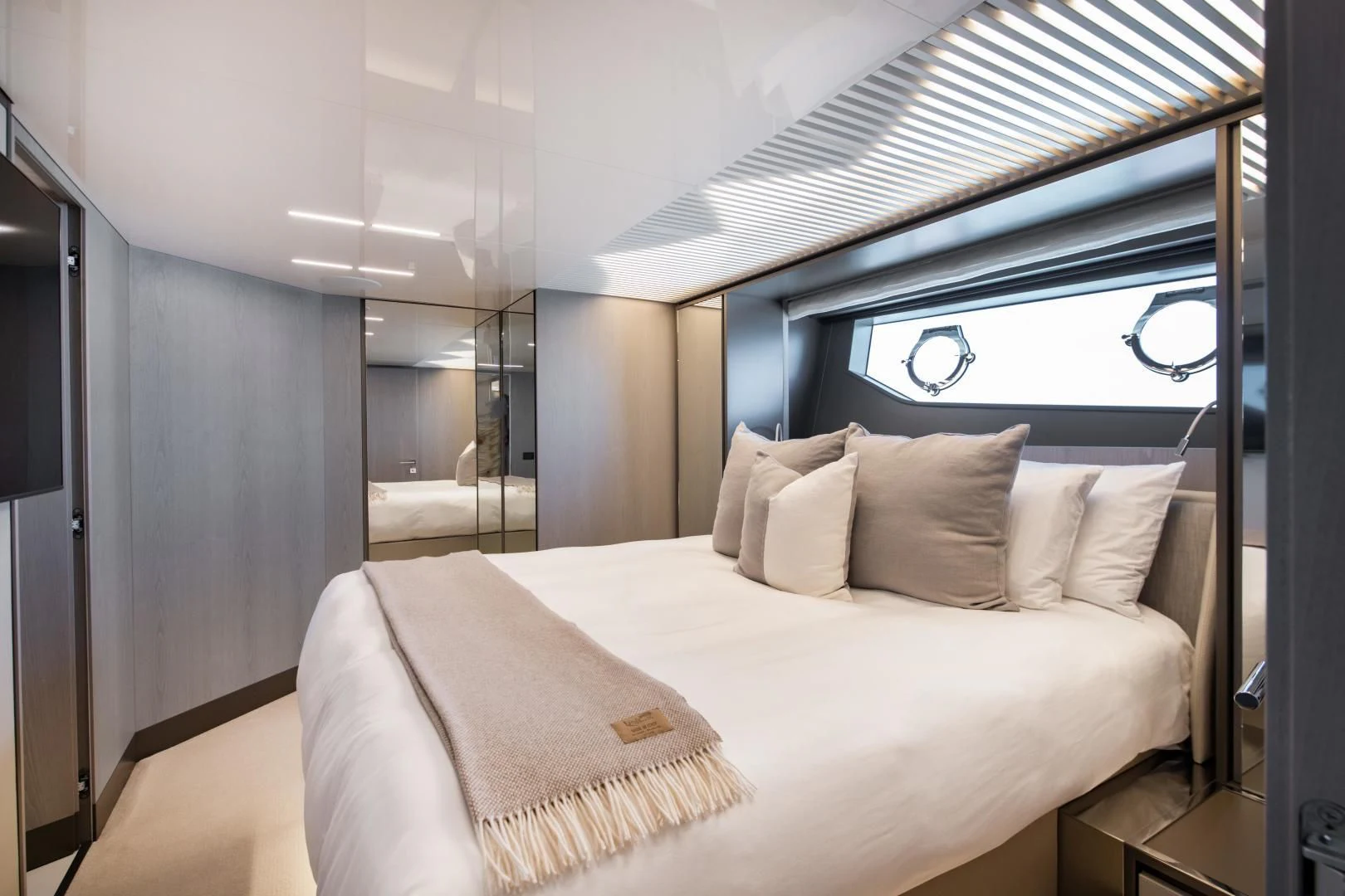 a bed with a white bed spread aboard ISLA MARIE Yacht for Sale