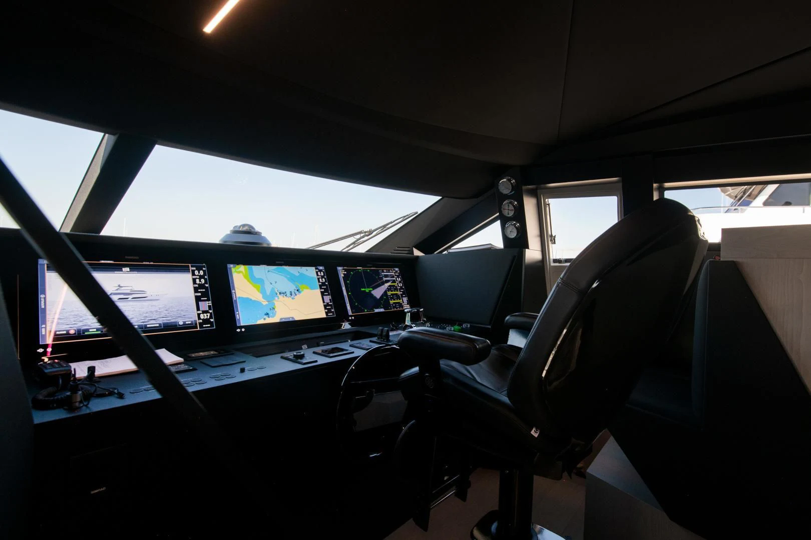 a view of a control room with many monitors and seats aboard ISLA MARIE Yacht for Sale
