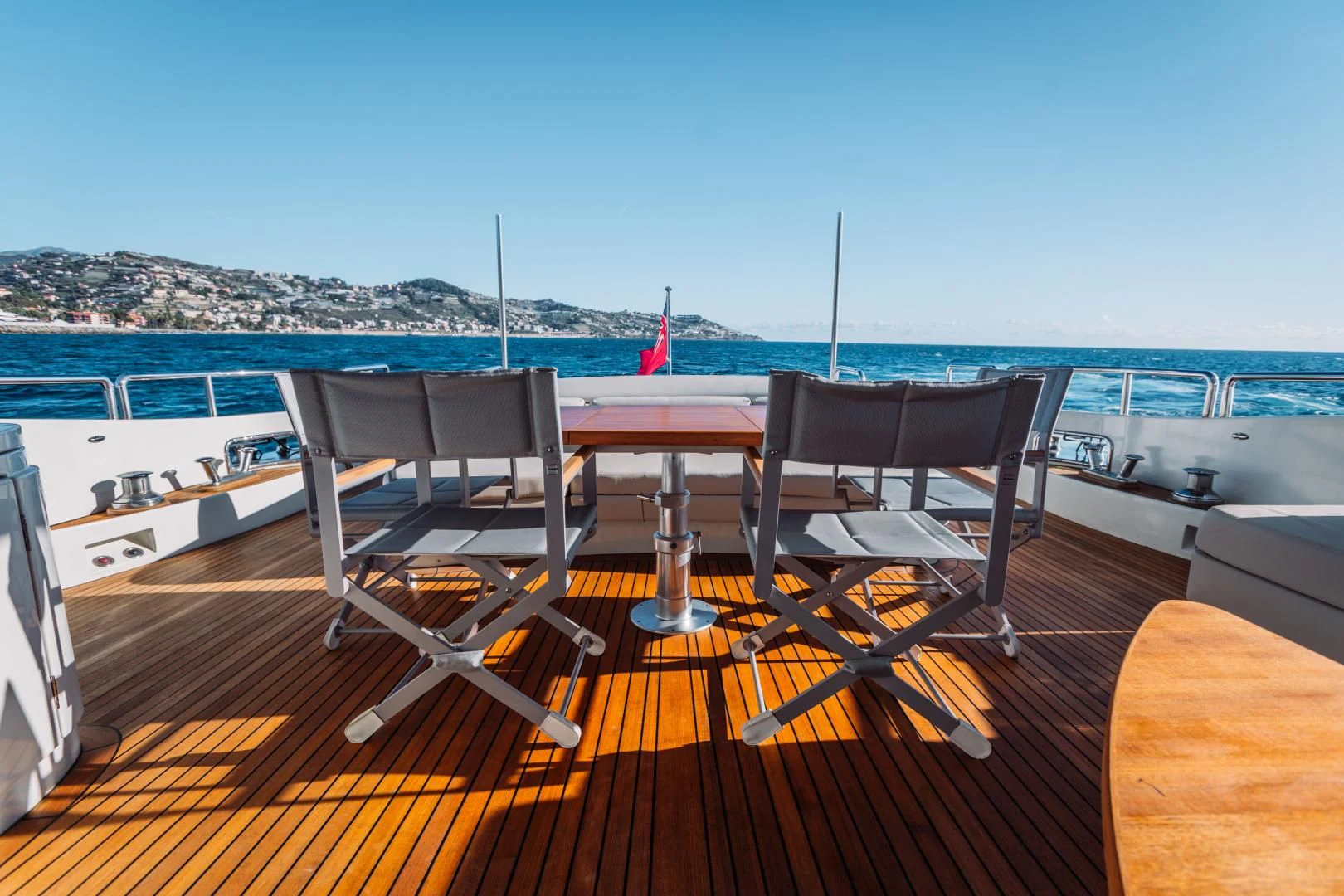 a deck with a view of the ocean and a city aboard NAMI Yacht for Sale