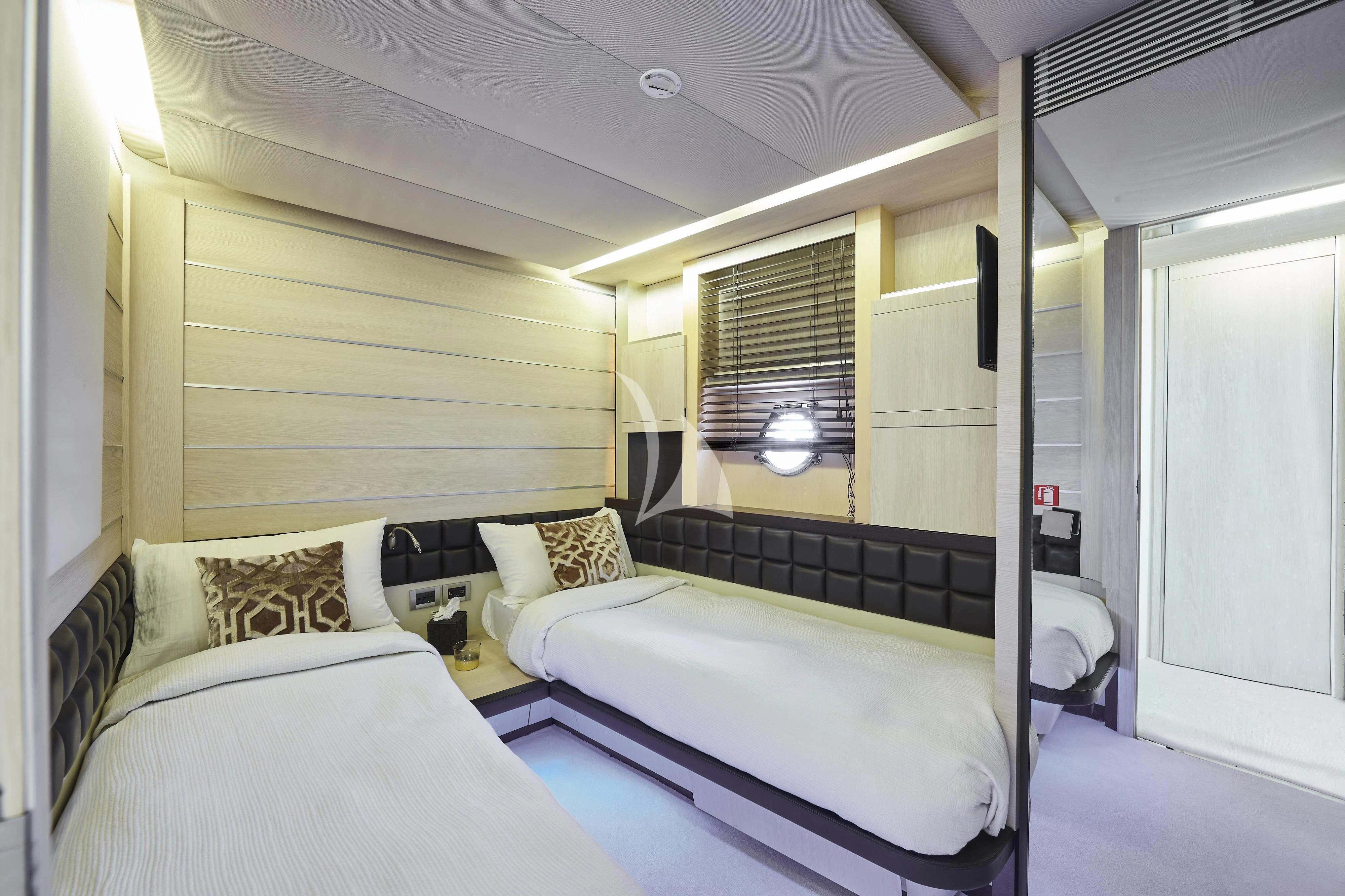 a couple of beds in a room aboard NAMI Yacht for Sale
