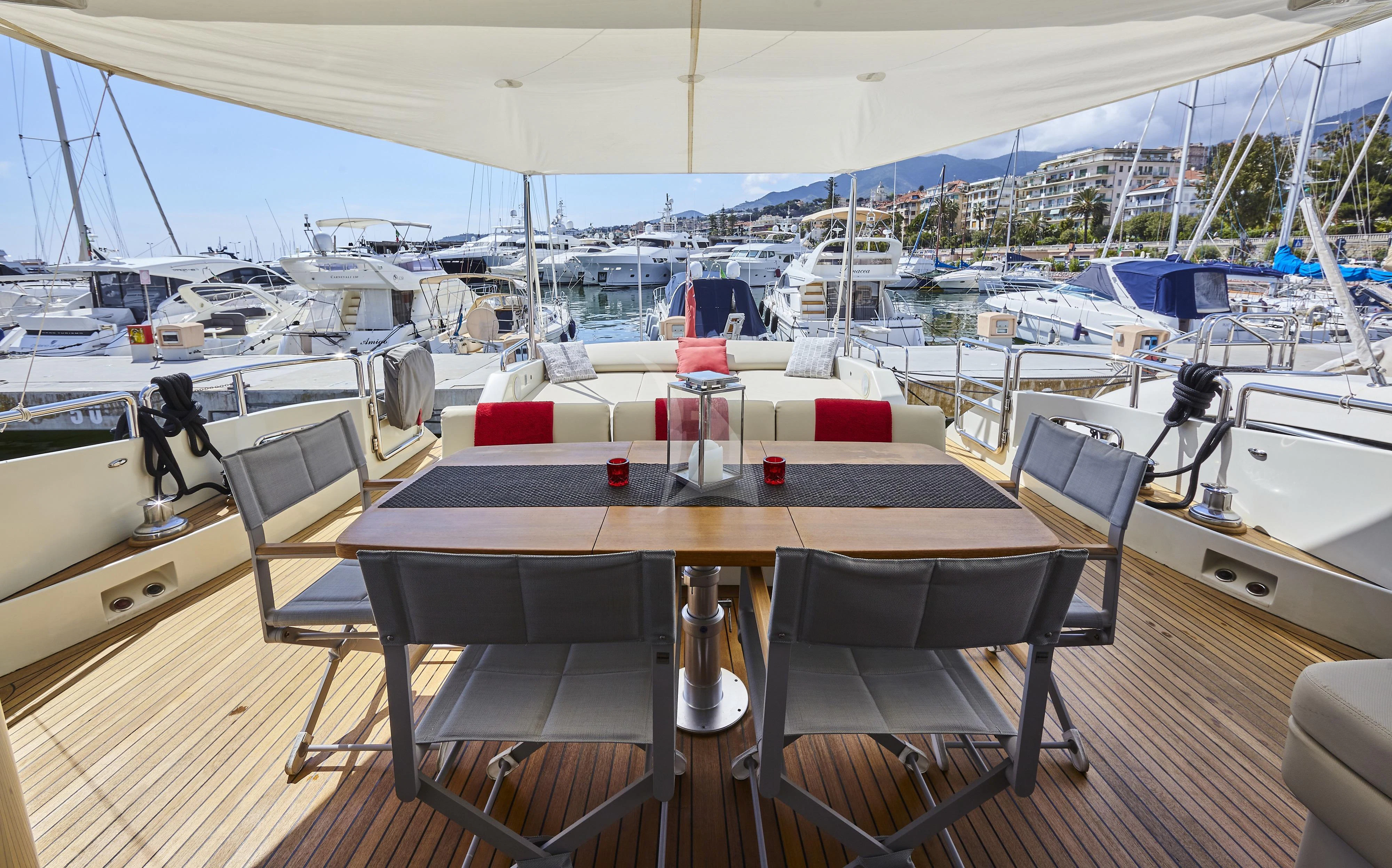 a table with chairs around it aboard NAMI Yacht for Sale