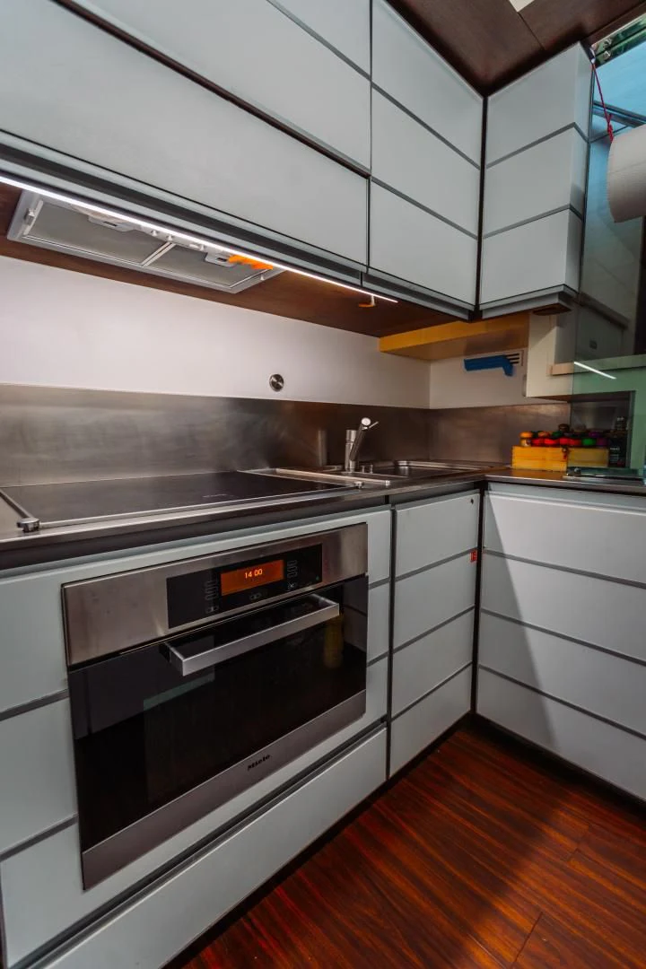 a kitchen with white cabinets aboard NAMI Yacht for Sale