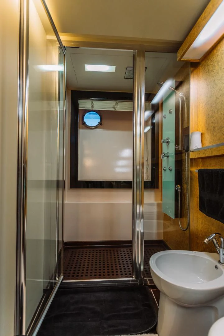 a bathroom with a glass shower aboard NAMI Yacht for Sale