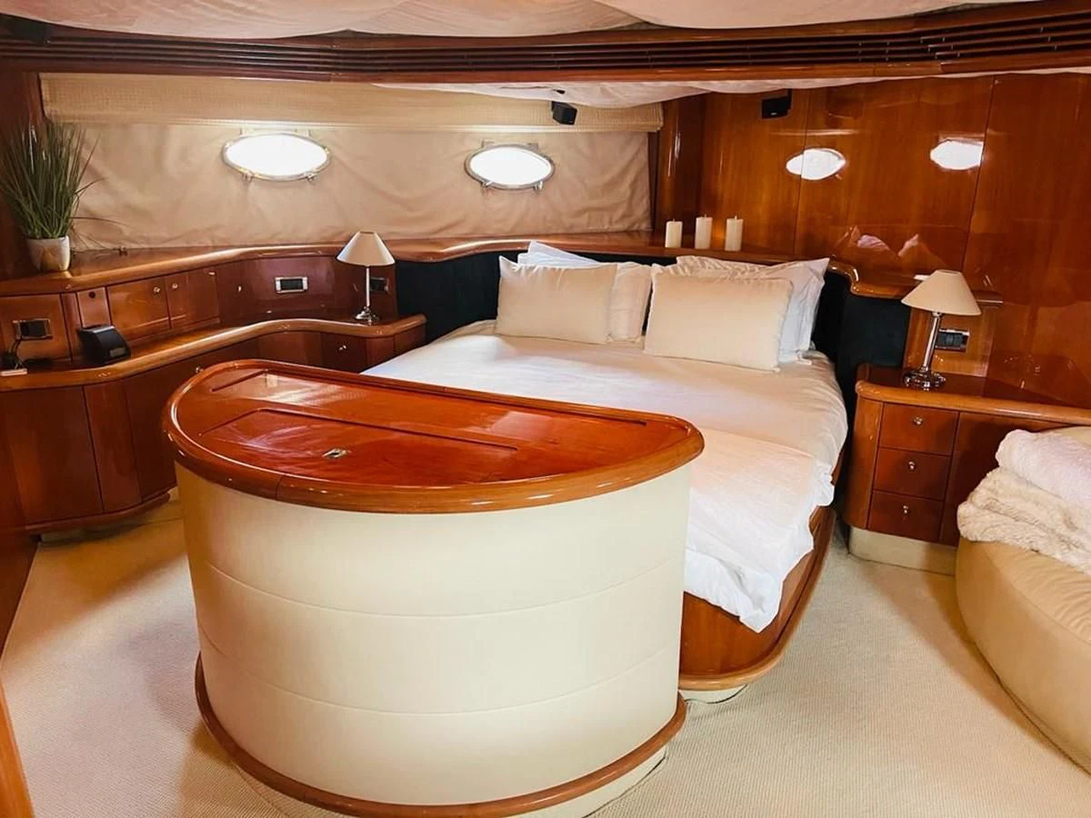 a room with a bed and a desk aboard LADY ESTHER Yacht for Sale