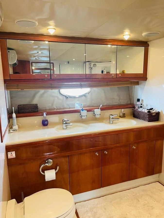 a bathroom with a large mirror aboard LADY ESTHER Yacht for Sale