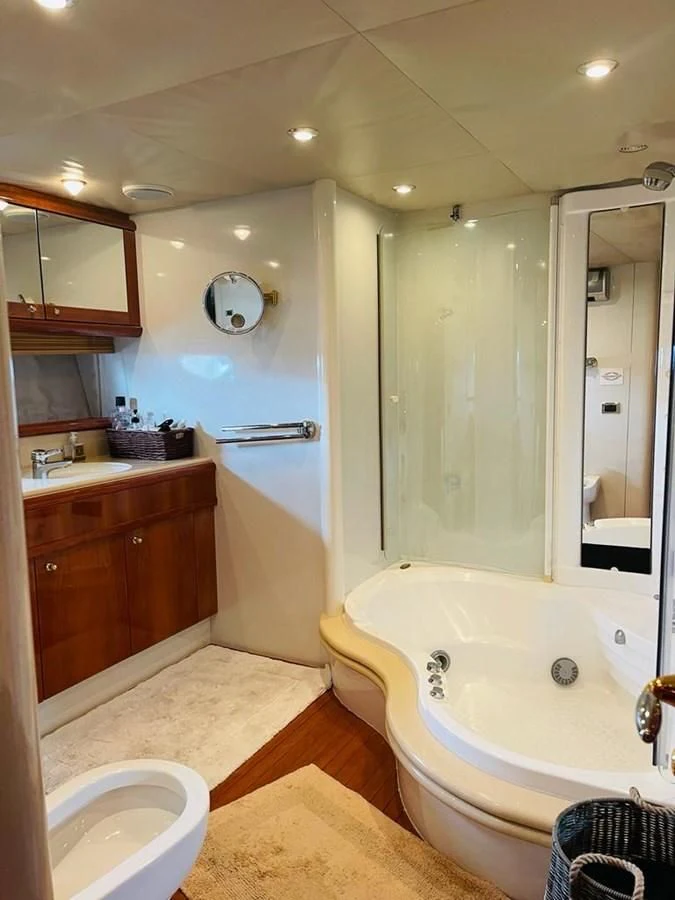 a bathroom with a tub sink and shower aboard LADY ESTHER Yacht for Sale